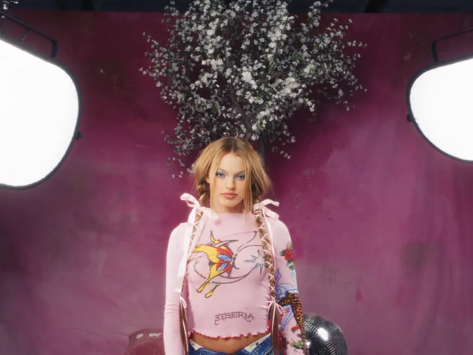 Realistic: a portrait on a pink set under studio lights
